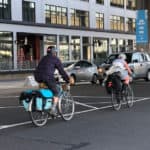 commuters riding bicycles in traffic