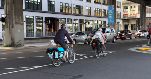 commuters riding bicycles in traffic