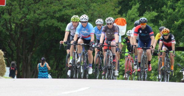 group of cyclists cresting hill
