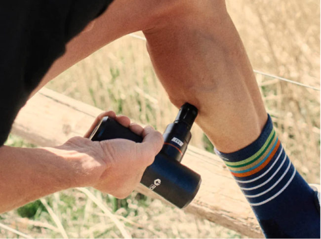 Roll Recovery R1 massage device used on a calf muscle