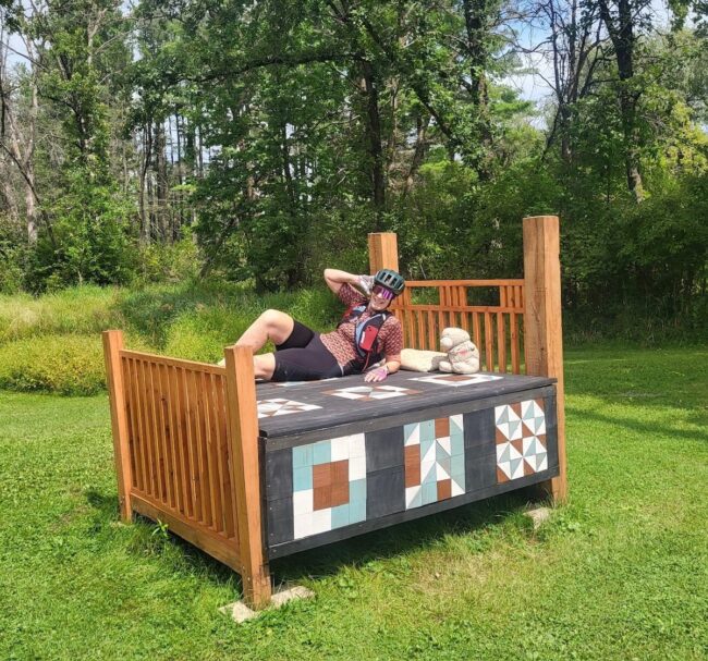 bed in field art on cycling adventure