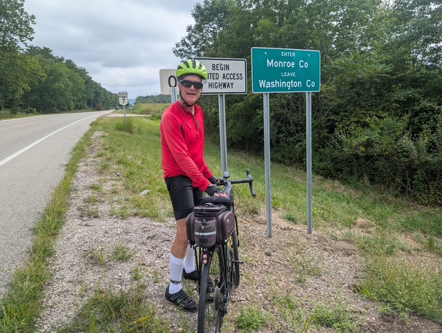 Peter at county line on cycling adventure