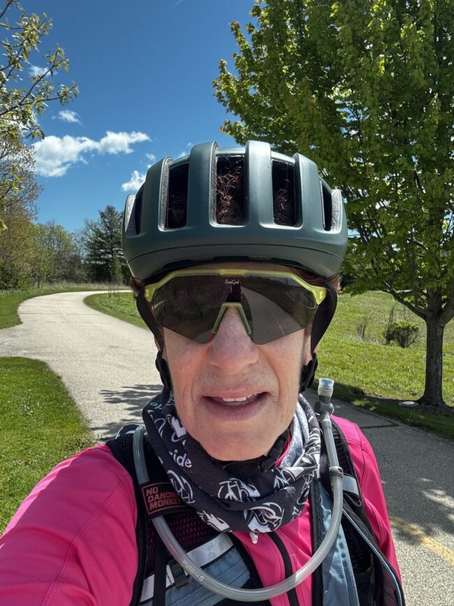Sheri Rosenbaum wearing SunGod Velans 2 sunglasses in Aurora Yellow on a bike path ride